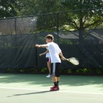 Student practicing tennis
