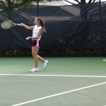 Student playing tennis